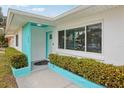 Front entrance with teal accents and landscaping at 956 Bruce Ave, Clearwater Beach, FL 33767