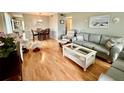 Living room with light wood floors, couches, and a coffee table at 2043 Denmark St # 57, Clearwater, FL 33763