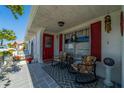 Relaxing front porch with rocking chairs and red shutters at 1207 Bluewater Dr, Sun City Center, FL 33573