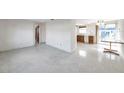 Open living room and kitchen with terrazzo floors at 12400 Park Blvd # 118, Seminole, FL 33772