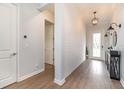 Bright entryway with wood-look floors, shiplap wall, and a console table at 13513 White Sapphire Rd, Riverview, FL 33579