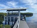 Covered boat dock with lift and open water access at 1643 Sea Breeze Dr, Tarpon Springs, FL 34689