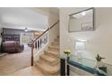 Staircase leading to the second floor with glass top table and mirror at 17347 Mint Leaf Ln, Land O Lakes, FL 34638