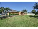 Single-Gathering house with a large front yard and driveway at 17409 New Cross Cir, Lithia, FL 33547