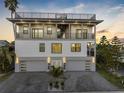 Beautiful modern home with a rooftop deck and two-car garage at 18077 3Rd St, Redington Shores, FL 33708