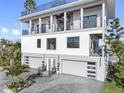 Luxury waterfront home with a rooftop deck and balconies at 18077 3Rd St, Redington Shores, FL 33708