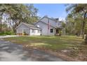 Gray house with attached garage and American flag at 19387 Hidden Oaks Dr, Brooksville, FL 34604