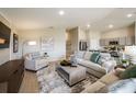 Open living space with kitchen view, neutral decor, and hardwood floors at 2103 Stillview Pass, Zephyrhills, FL 33541