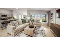 Bright and airy living room with beige sofas and large windows at 2103 Stillview Pass, Zephyrhills, FL 33541