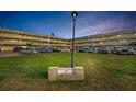 A view of the complex parking lot and lawn with the sign for Royal Chateau 2221 at 2221 Swedish Dr # 11, Clearwater, FL 33763