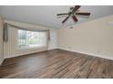 Bright living room with gorgeous wood-look flooring, a ceiling fan, and lots of natural light at 2221 Swedish Dr # 11, Clearwater, FL 33763