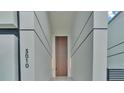 Elegant entryway with a tall wooden door and modern lighting at 3010 W Trilby Ave, Tampa, FL 33611