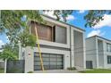 Contemporary home with clean lines, a glass garage door, and a modern fence at 3010 W Trilby Ave, Tampa, FL 33611