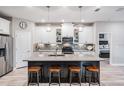 Modern kitchen with white cabinets, gray countertops, and a large island at 34432 Wynthorne Pl, Wesley Chapel, FL 33545