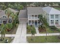 Two story house with a large yard, driveway and neutral color scheme at 406 Manns Harbor Dr, Apollo Beach, FL 33572