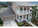 Two-story house with a large yard, driveway and neutral color scheme at 406 Manns Harbor Dr, Apollo Beach, FL 33572