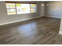 Spacious living room featuring light grey walls and wood-look flooring at 6720 35Th N Ter, St Petersburg, FL 33710