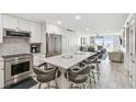 Modern kitchen featuring granite countertops and stainless steel appliances at 7 Elgin Pl # 603, Dunedin, FL 34698