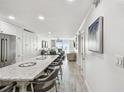 Open concept kitchen with granite countertops and stainless steel appliances at 7 Elgin Pl # 603, Dunedin, FL 34698