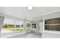 Front porch with screened enclosure, view of yard at 10308 Forest Hills Dr, Tampa, FL 33612