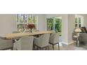Bright dining area with a wooden table and six chairs at 10873 Gentle Current Way, Parrish, FL 34219