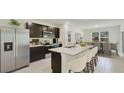 Modern kitchen with stainless steel appliances and an island at 10873 Gentle Current Way, Parrish, FL 34219