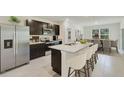 Modern kitchen with stainless steel appliances and an island at 10873 Gentle Current Way, Parrish, FL 34219