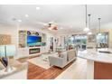 Open living space with hardwood floors, fireplace, and large windows at 11807 Summer Springs Dr, Riverview, FL 33579