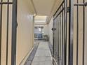 Private gated entry to condo with a stone path at 1581 Amberlea S Dr, Dunedin, FL 34698