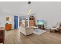 Bright living room with hardwood floors and large windows at 1581 Amberlea S Dr, Dunedin, FL 34698