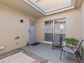 Cozy condo patio with seating and a skylight at 1581 Amberlea S Dr, Dunedin, FL 34698