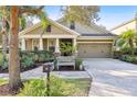 House exterior featuring a two-car garage and a manicured lawn at 15811 Oakleaf Run Dr, Lithia, FL 33547