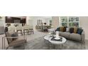 Open living space with a gray sofa and two nesting coffee tables at 17217 Wheatberry Blvd, Parrish, FL 34219