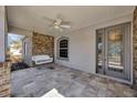 Relaxing front porch features a white swing and ceiling fan at 2402 Cumberland Cliff Dr, Ruskin, FL 33570