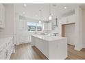 Modern white kitchen with stainless steel appliances and quartz countertops at 2506 W Cleveland St # 18, Tampa, FL 33609