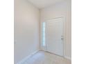 Simple entryway with tile flooring and a white door at 26519 Castleview Way, Wesley Chapel, FL 33544