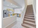 Kitchen features light wood cabinets, stainless steel appliances, and tile flooring at 26519 Castleview Way, Wesley Chapel, FL 33544