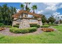 Stone sign for Vista Lakes community with landscaping and a pergola at 3238 Mela Ct, Holiday, FL 34691