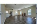 Open floor plan with new vinyl flooring, neutral walls, and stainless steel refrigerator at 3729 Winward Lakes Dr, Tampa, FL 33611