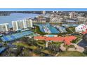Aerial view showing community amenities including tennis courts and a pool at 7893 Sailboat Key S Blvd # 304, South Pasadena, FL 33707