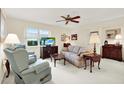 Bright living room featuring comfortable seating and a large window at 8086 Annwood Rd, Seminole, FL 33777