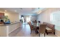 Kitchen and dining area with breakfast nook and modern lighting at 10251 Carloway Hills Dr, Wimauma, FL 33598