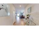 A view down a light and bright hallway showcasing stylish decor at 10251 Carloway Hills Dr, Wimauma, FL 33598