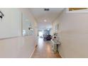 Bright entry hallway with tile floors, leading to the dining and living areas at 10251 Carloway Hills Dr, Wimauma, FL 33598