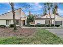 Front view of condo showing updated exterior and landscaping at 104 Capri S Ct, Plant City, FL 33566