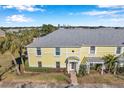 Exterior view of a yellow building with palm trees and a walkway at 107 Seahorse Se Dr # A, St Petersburg, FL 33705