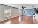 Spacious living room featuring hardwood floors and ceiling fan at 15406 Peach Stone Pl, Ruskin, FL 33573