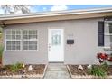 White front door with glass accents and landscaping at 1642 49Th N Ave, St Petersburg, FL 33714