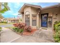 Villa front door entrance with well manicured landscaping at 1673 Nash Ct, Dunedin, FL 34698