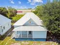 Single story light blue house with a metal roof, and a small yard at 2314 E 12Th Ave, Tampa, FL 33605